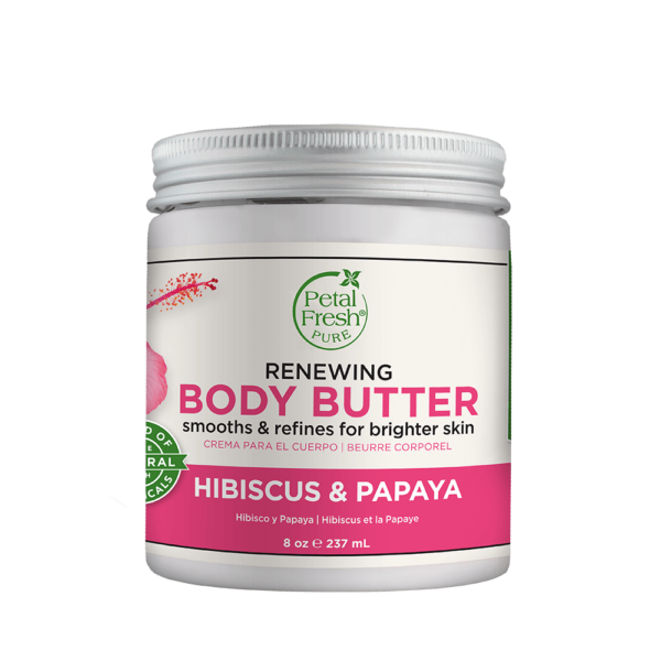 Image of Petal Fresh Renewing Hibiscus Papaya Body Butter. The jar is open, revealing a rich, creamy body butter inside, with a light pink color and a tropical hibiscus flower on the label. In the background, there are tropical leaves and flowers, highlighting the natural ingredients used in the product.